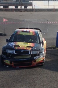 John Stone drags his car to the end of stage 10 after his incident.